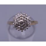 A 9 ct gold diamond cluster ring. Ring size K/L. 2.7 grammes total weight.