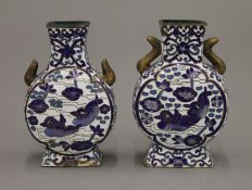 A pair of Chinese blue cloisonne vases decorated with Mandarin ducks and birds. 10 cm high.