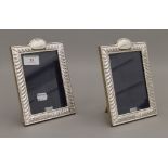 A pair of silver photograph frames. 19 cm high.