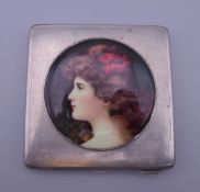 A silver cigarette case depicting a girl. 7 cm wide.