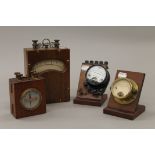 Four vintage ampere meters. The largest 20 cm high.