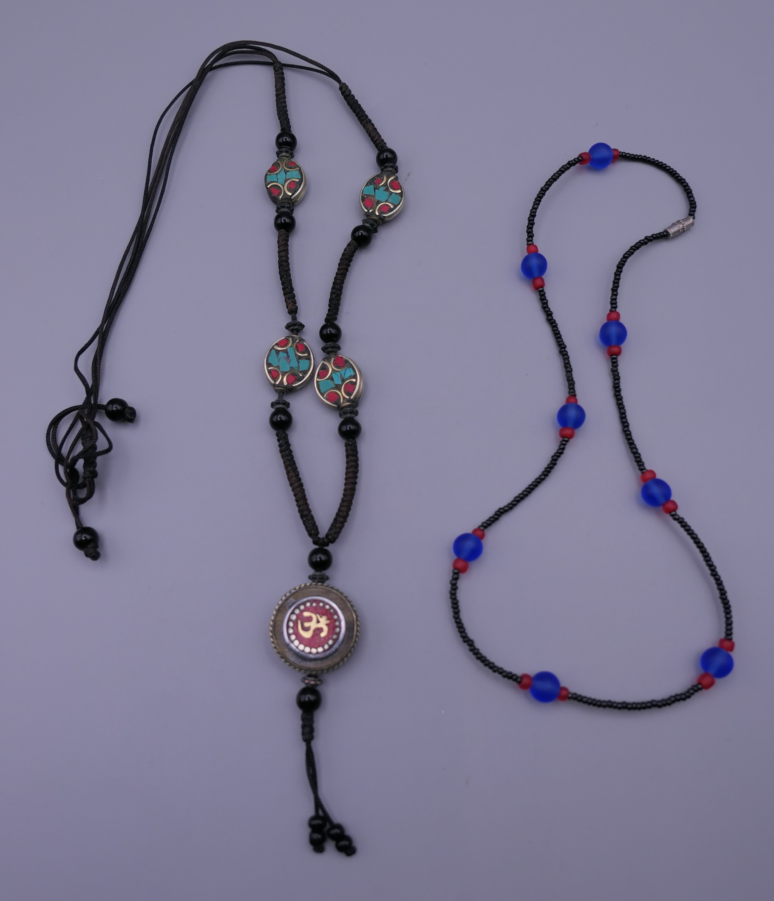 A Tibetan necklace and an African glass bead necklace.