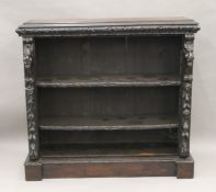 A Victorian carved oak bookcase. 126 cm wide.