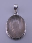 A silver rutilated quartz pendant. 3.5 cm high.