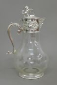 A silver plated topped claret jug, the lid surmounted with a lion. 29 cm high.