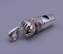 A silver whistle formed as a hand. 4 cm long.