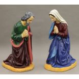 A vintage painted plaster nativity set comprising Mary, Joseph, the Baby Jesus and a bull.