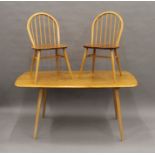 A blonde Ercol dining table and set of six Ercol chairs. The table 155 cm long.