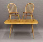 A blonde Ercol dining table and set of six Ercol chairs. The table 155 cm long.