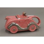 An early 20th century porcelain racing car form teapot.