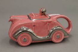 An early 20th century porcelain racing car form teapot.