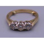 An 18 ct gold diamond three stone ring. 1/2 carat diamond weight. Ring size L. 2.