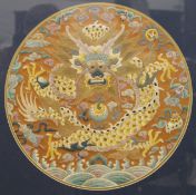 A Chinese embroidery of a dragon amongst clouds, framed and glazed. 39 x 39 cm.