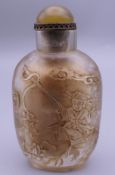 A Chinese carved glass snuff bottle. 9 cm high.