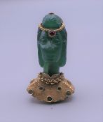 An 18 ct gold mounted emerald set pendant formed as a female bust. 4 cm high.