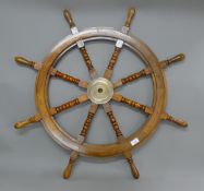 A wooden ship's wheel. 93 cm diameter overall.