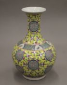 A Chinese porcelain yellow vase decorated with peaches. 37 cm high.