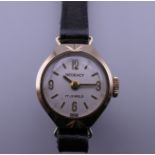 A 9 ct gold vintage Regency 17 jewel ladies wristwatch on a leather strap,