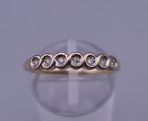 A 9 ct gold seven stone diamond ring. Ring size O. 1.9 grammes total weight.
