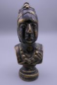 A brass pipe tamper formed as the bust of Queen Victoria. 6 cm high.