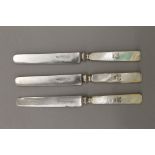 Three 19th century mother-of-pearl handled knives, each bearing coronet. 19.5 cm long.