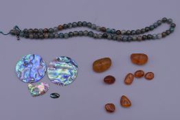 A small quantity of amber, abalone and a string of agate beads.