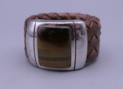 A woven leather tiger's eye and silver ring. Ring size P/Q.