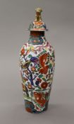 A 19th century lidded porcelain vase, the lid profusely painted with dragons, fish, giraffe,