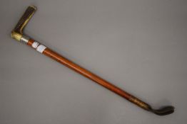 A silver mounted riding crop and a violin bow. The former 58 cm long.