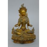 A gilt bronze model of Buddha decorated with coral and turquoise. 21.5 cm high.