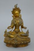 A gilt bronze model of Buddha decorated with coral and turquoise. 21.5 cm high.