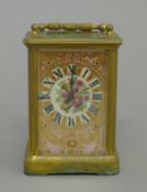 A brass cased carriage clock with painted porcelain panels. 14 cm high.