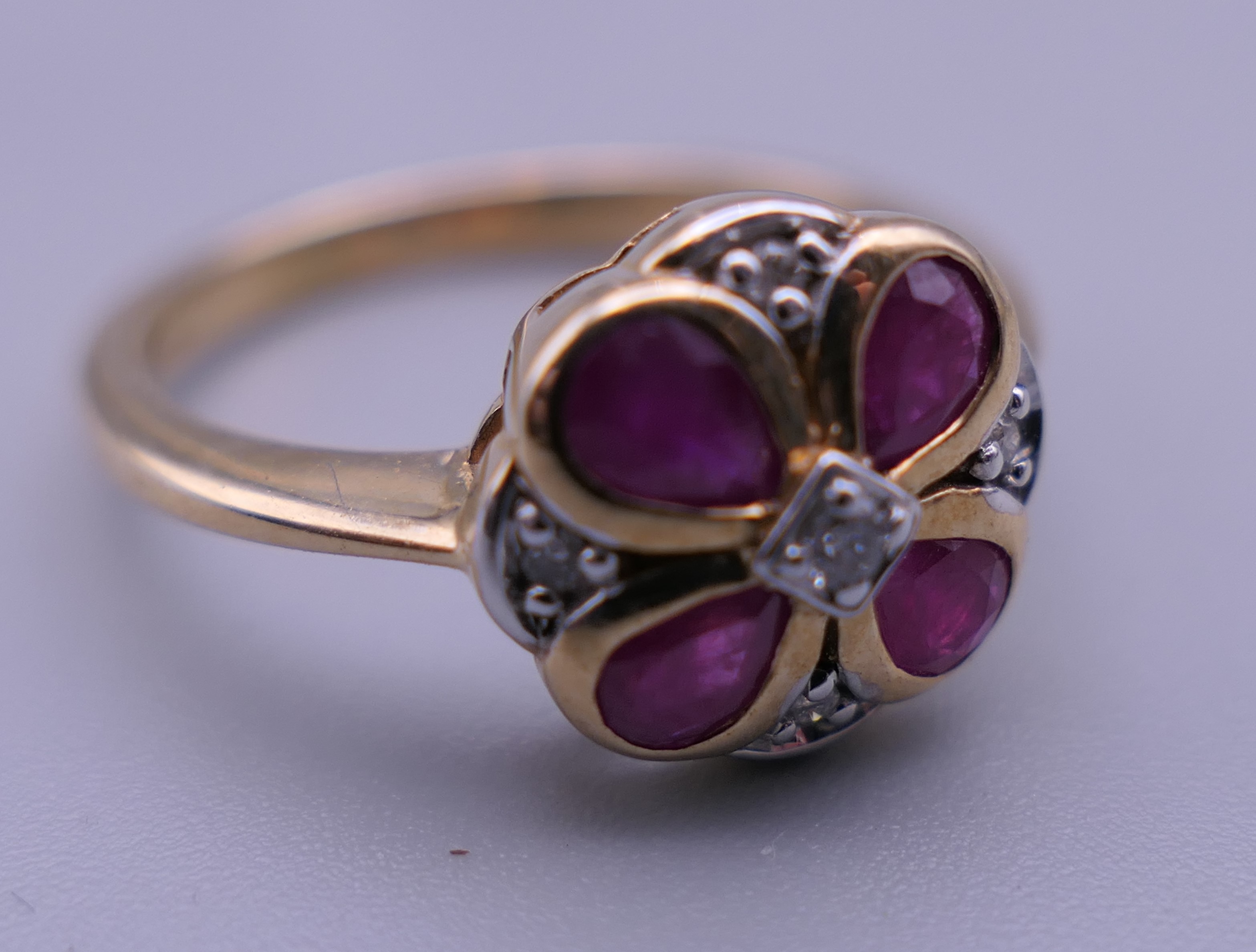 A 9 ct gold ruby and diamond flower ring. Ring size M. - Image 5 of 6