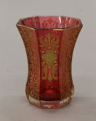 A 19th century Bohemian octagonal cranberry glass with gilt decoration. 11 cm high.