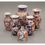 Four Imari style vases and a small pot.