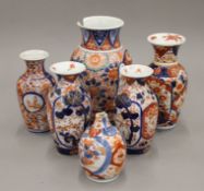 Four Imari style vases and a small pot.