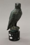 A patinated bronze model of a falcon on a plinth base. 31 cm high.