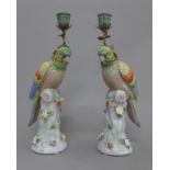 A pair of porcelain parrot form candlesticks. 36 cm high.