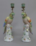 A pair of porcelain parrot form candlesticks. 36 cm high.