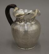 A ribbed silver jug. 14 cm high. 363.4 grammes total weight.