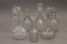 A quantity of various cut glass decanters.