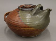 A hand thrown teapot, indistinct potters mark under spout, possibly MU, possibly 1960's/70's.