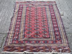 A red and blue ground wool rug. 128 x 196 cm.