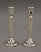 A pair of silver candlesticks. 19 cm high.