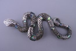 A silver marcasite and abalone snake pendant. 8.5 cm long.