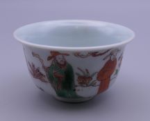 A small Chinese porcelain tea bowl decorated with figures. 7.25 cm diameter.
