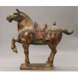 A large Tang style painted wooden model of a horse. 87 cm long.