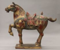A large Tang style painted wooden model of a horse. 87 cm long.