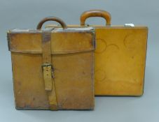 A leather case and a pig skin case. The former 33 cm wide.