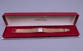 A 9 ct gold ladies Omega wristwatch, in Omega box. 24.5 grammes total weight.